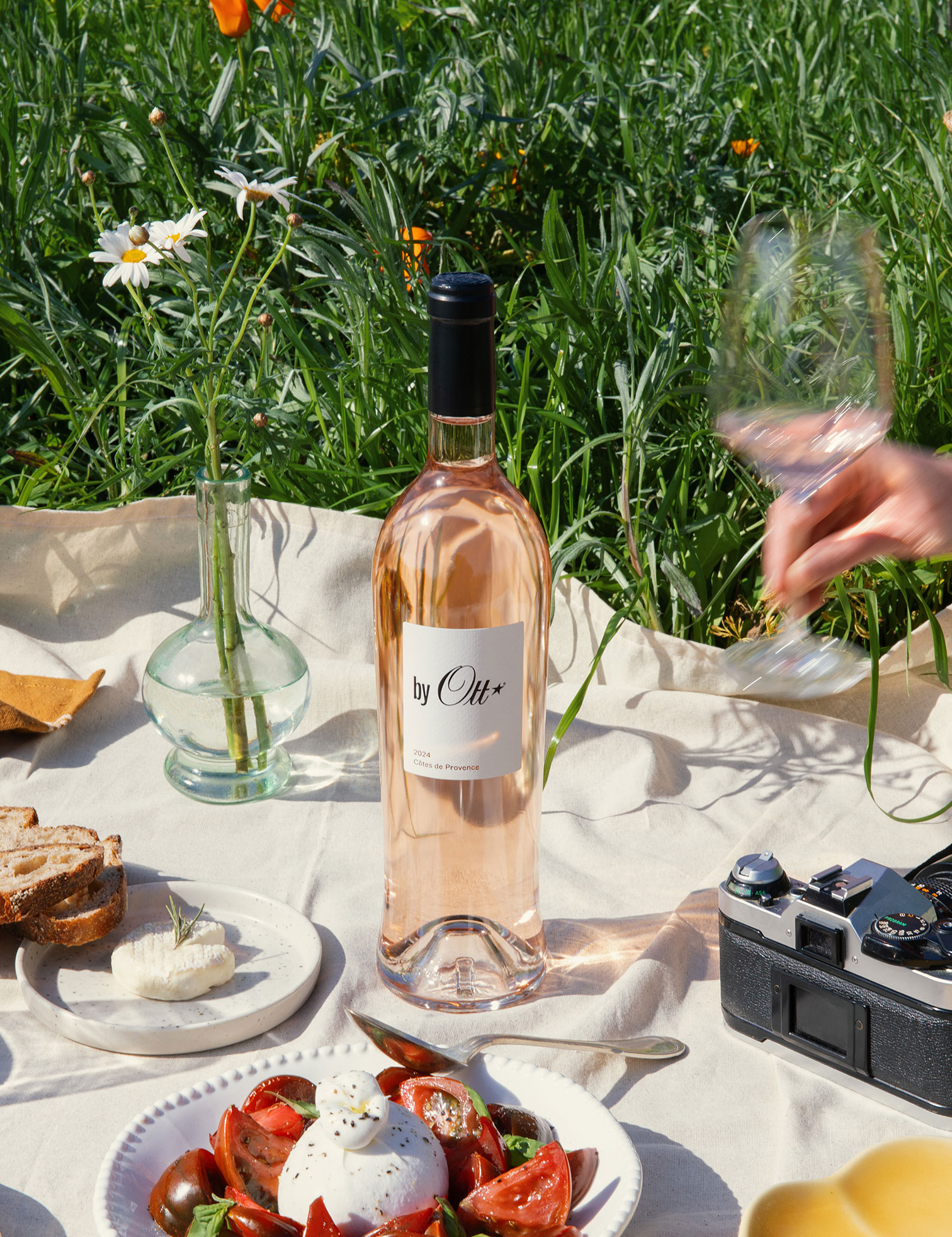 a-glass-of-rose-wine-in-the-centre-of-a-picnic-tablecloth